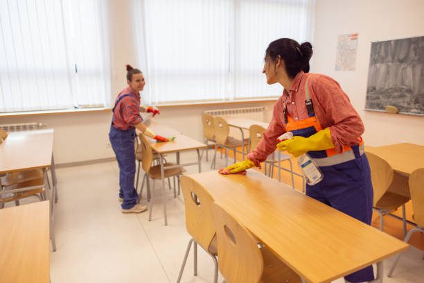 Female janitors cleaning classrooms for new school year